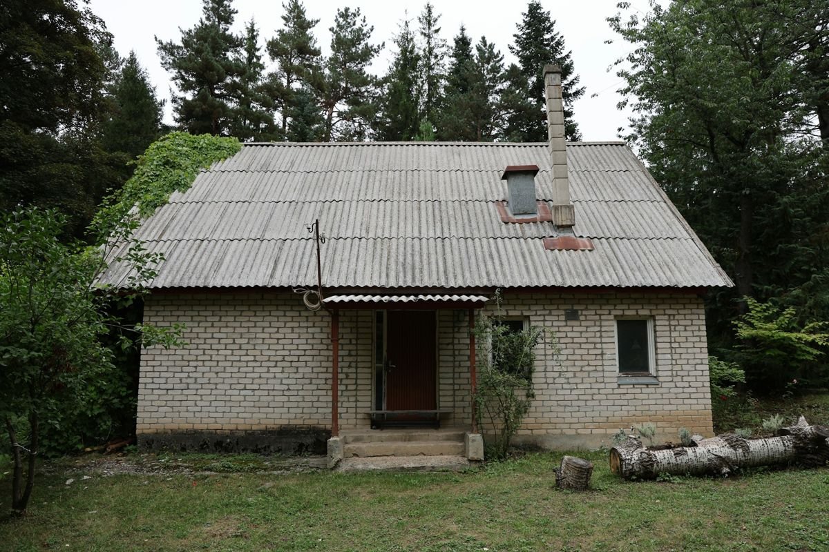 Casa de ladrillo con cubierta de placas onduladas de fibrocemento envejecidas